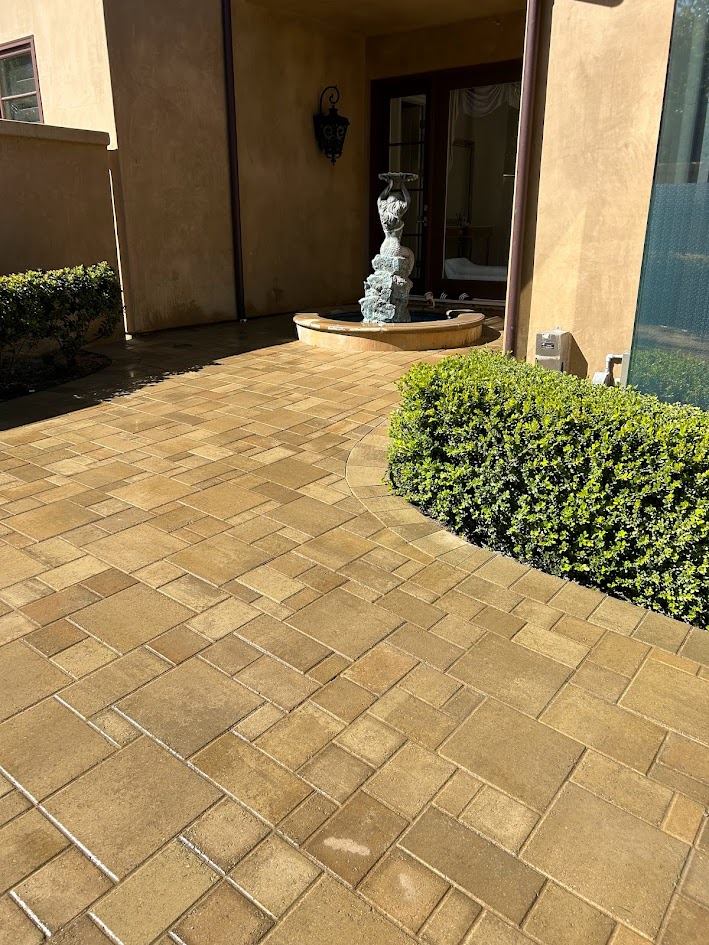 Curved paver walkway leading to the entry fountain