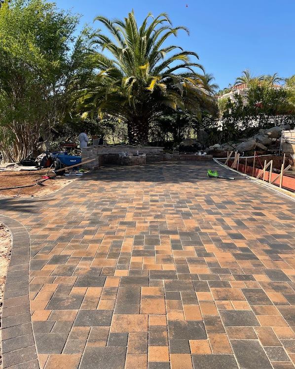 Large curved paver patio beneath a deck in El Cajon, San Diego