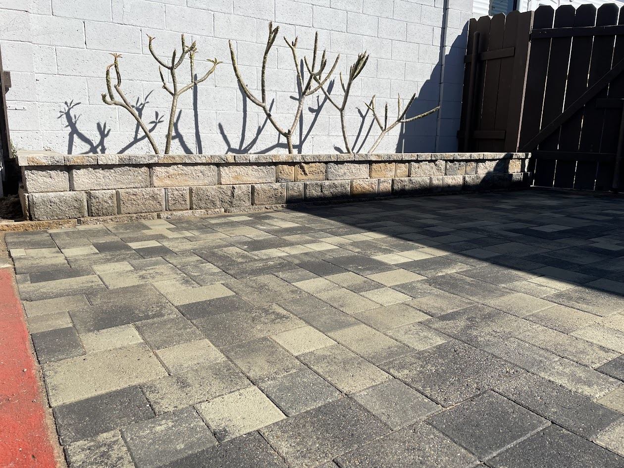 Stacked stone seat wall and new planting along a paver patio in La Mesa
