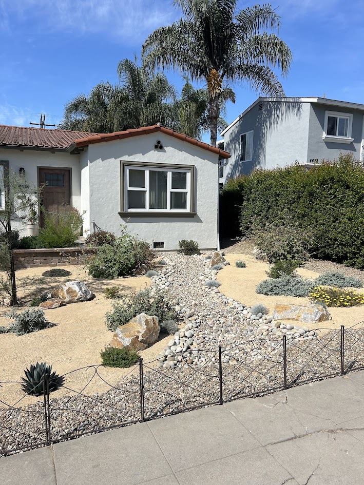 Dry creek bed and decomposed granite front yard planting in San Diego
