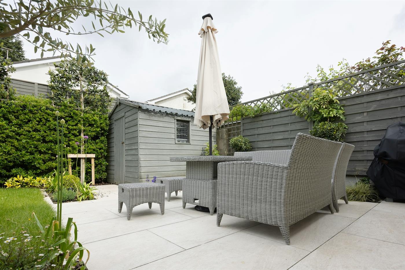 Fully designed backyard patio with seating area and garden plantings
